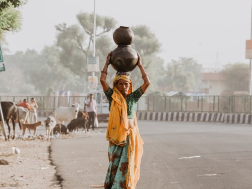 Woman carrying pots of water in India or Pakistan